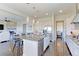 Open concept kitchen with granite island, stainless appliances, and seamless flow to living area at 4220 Kestrel Dr, Broomfield, CO 80023