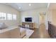 View of the second story living room with vaulted ceilings, a large TV, and a cozy couch at 4220 Kestrel Dr, Broomfield, CO 80023