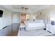 Bright main bedroom features tray ceiling, barn door to ensuite bath, and bench at the foot of the bed at 4220 Kestrel Dr, Broomfield, CO 80023
