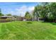 Wide view of the backyard with green lawn, pergola and patio at 8525 Grandview Ave, Arvada, CO 80002