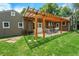 Beautiful backyard features a charming pergola-covered patio, perfect for outdoor dining and entertaining at 8525 Grandview Ave, Arvada, CO 80002
