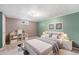 Cozy bedroom with green and brown walls, a white bed frame and shelving for storage at 8525 Grandview Ave, Arvada, CO 80002