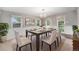Dining room with table and six chairs, chandelier, wainscotting, and neutral walls at 8525 Grandview Ave, Arvada, CO 80002