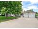 Charming single-story home with a well-manicured lawn, mature shade tree, and an attached two-car garage at 8525 Grandview Ave, Arvada, CO 80002
