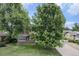 Charming home with mature trees, a well-kept lawn, and classic architectural details at 8525 Grandview Ave, Arvada, CO 80002