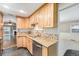 Kitchen featuring wood cabinets, stainless steel appliances, and granite countertops at 8525 Grandview Ave, Arvada, CO 80002