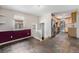 Kitchenette with stairs leading up and an exterior door. Tile floor at 8525 Grandview Ave, Arvada, CO 80002