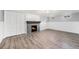 Cozy living room with stylish wood flooring, fireplace, white wainscoting, and ample closet space at 8525 Grandview Ave, Arvada, CO 80002
