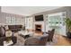 Stylish living room with a cozy fireplace, comfortable seating, and ample natural light at 8525 Grandview Ave, Arvada, CO 80002