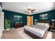 Nicely decorated main bedroom featuring dark teal walls, modern art, and a comfortable bed at 8525 Grandview Ave, Arvada, CO 80002