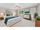 Main bedroom with neutral paint, carpet, ceiling fan, and decorated in an earth-tone palette at 8525 Grandview Ave, Arvada, CO 80002