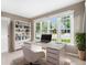 Bright home office with a large desk, built-in shelving, and expansive windows providing natural light at 8525 Grandview Ave, Arvada, CO 80002