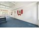 Covered porch with blue carpet, white walls and red shutters creating a warm, inviting space at 8525 Grandview Ave, Arvada, CO 80002