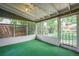 Cozy sunroom with screened windows, neutral paint, and views of the backyard at 8525 Grandview Ave, Arvada, CO 80002
