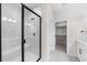 Modern bathroom with a large shower, built-in bench, and walk-in closet at 7210 Watercress Dr, Littleton, CO 80125