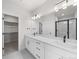 Double vanity bathroom with walk-in shower and closet at 7210 Watercress Dr, Littleton, CO 80125