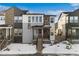 Stunning two-story home with gray siding and stone accents at 7210 Watercress Dr, Littleton, CO 80125