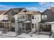 Modern two-story home with gray and white exterior, and snowy front yard at 7210 Watercress Dr, Littleton, CO 80125