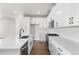 White kitchen with stainless steel appliances and an island at 7210 Watercress Dr, Littleton, CO 80125