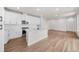 Open concept kitchen with white cabinets and island, overlooking living room at 7210 Watercress Dr, Littleton, CO 80125