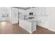 Modern kitchen featuring white cabinets, quartz countertops, and an island at 7210 Watercress Dr, Littleton, CO 80125