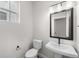 Modern powder room with pedestal sink and black accents at 7210 Watercress Dr, Littleton, CO 80125