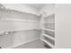 Large walk-in closet with hanging rods and shelving at 7210 Watercress Dr, Littleton, CO 80125