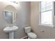 Powder room with pedestal sink, and a window with natural light at 2920 Deerfoot Way, Castle Rock, CO 80109