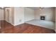 Open living space featuring hardwood floors, a fireplace, and an adjacent foyer at 2920 Deerfoot Way, Castle Rock, CO 80109