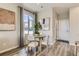 Bright dining area with a round table and four chairs, hardwood floors and large window at 468 Millwall Cir, Castle Pines, CO 80108