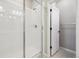 Shower with tiled walls and glass door in a bright bathroom at 468 Millwall Cir, Castle Pines, CO 80108