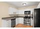 Well-equipped kitchen with stainless steel appliances, ample cabinet space, and hardwood floors at 720 S Clinton St # 1B, Denver, CO 80247