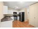 Functional kitchen with stainless steel appliances, ample cabinet space, and hardwood floors at 720 S Clinton St # 1B, Denver, CO 80247