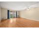 Bright, airy living room showcasing hardwood floors and a private balcony with scenic views at 720 S Clinton St # 1B, Denver, CO 80247