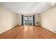 Bright, airy living room showcasing hardwood floors and a private balcony with scenic views at 720 S Clinton St # 1B, Denver, CO 80247