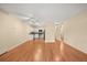 Open-concept living area featuring hardwood floors, a ceiling fan, and a kitchen with modern appliances at 720 S Clinton St # 1B, Denver, CO 80247