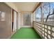 This outdoor patio is screened in with art deco features and has faux grass at 720 S Clinton St # 1B, Denver, CO 80247