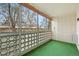 This outdoor patio is screened in with art deco features and has faux grass at 720 S Clinton St # 1B, Denver, CO 80247