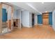 Open basement undergoing renovation, featuring exposed beams and modern lighting at 13341 Birch Cir, Thornton, CO 80241