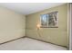 Neutral bedroom featuring a window for natural light and carpeted floors at 13341 Birch Cir, Thornton, CO 80241