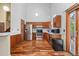 A well-lit kitchen with stainless steel appliances, wood cabinets, and hardwood floors at 13341 Birch Cir, Thornton, CO 80241