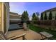 A relaxing backyard featuring a spacious patio, dark stained deck, wooden chairs and a barbecue grill at 1126 S Davenport Ct, Erie, CO 80516