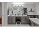 Bright bathroom featuring double sinks, vanity area, and a shower, with modern fixtures and decor at 1126 S Davenport Ct, Erie, CO 80516