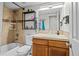 Bathroom featuring tiled walls, shower-tub combo, and floating shelves at 1126 S Davenport Ct, Erie, CO 80516