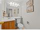 Cozy bathroom with wood vanity, decorative artwork, and ample lighting at 1126 S Davenport Ct, Erie, CO 80516