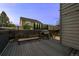 View of the dark stained wood deck, looking over the backyard, with a barbecue grill and seating at 1126 S Davenport Ct, Erie, CO 80516
