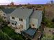 Aerial view of the home's exterior showing the large deck and patio, well manicured lawn, and mature trees at 1126 S Davenport Ct, Erie, CO 80516