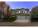 Charming two-story home with a stone accent, three-car garage, and well-maintained lawn at twilight at 1126 S Davenport Ct, Erie, CO 80516