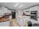 Modern kitchen with white cabinets, butcher block island, stainless steel appliances, and dark countertops at 1126 S Davenport Ct, Erie, CO 80516