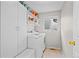 Efficient laundry room with washer, dryer, and built-in storage at 1126 S Davenport Ct, Erie, CO 80516